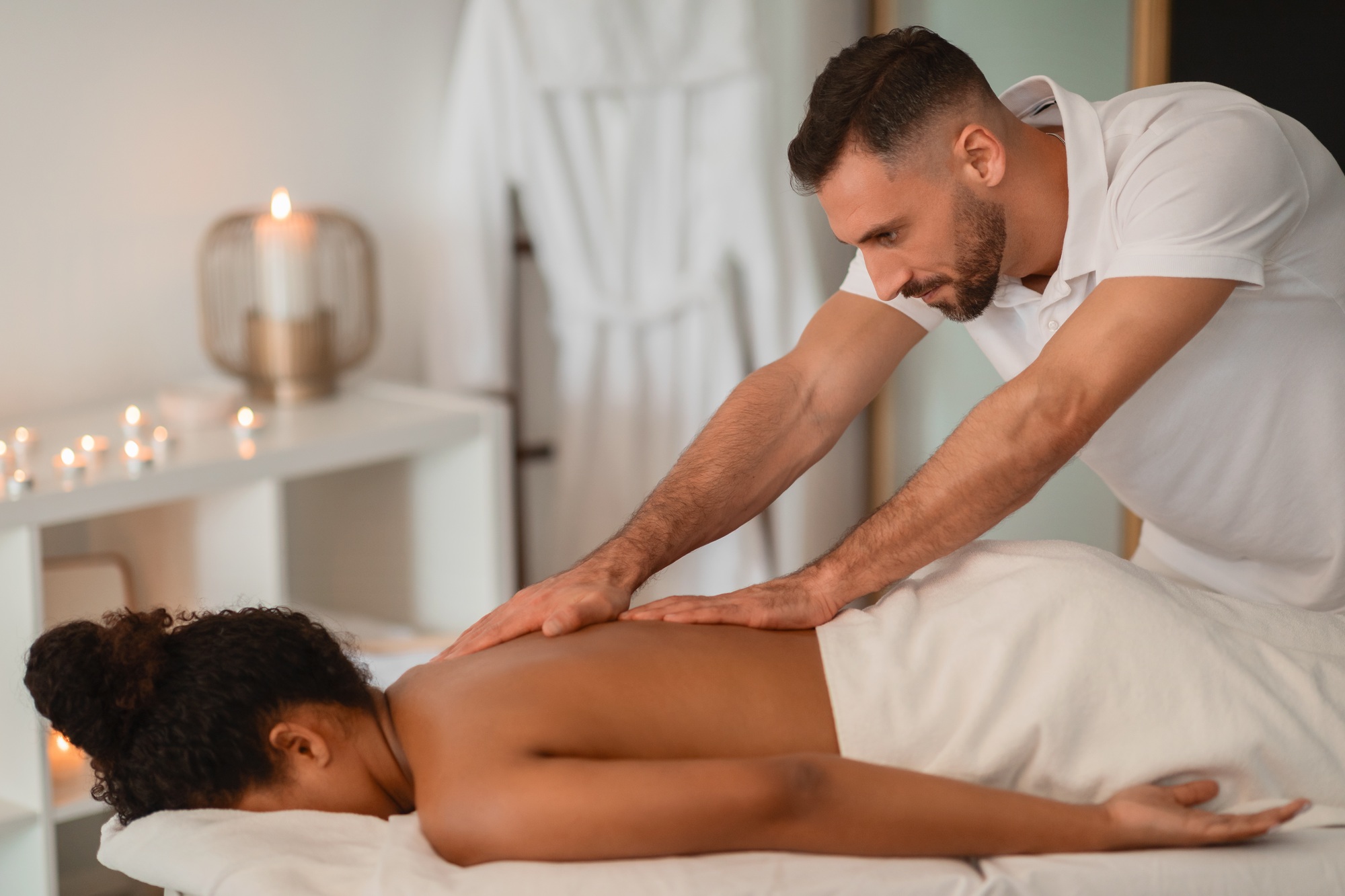 Massage therapist working on African American lady